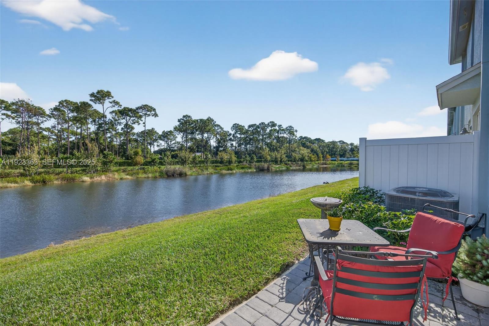 5746 Southeast Edgewater Circle Stuart, FL 34997 - Photo 30 of 38 a view of a house with a yard and a lake view