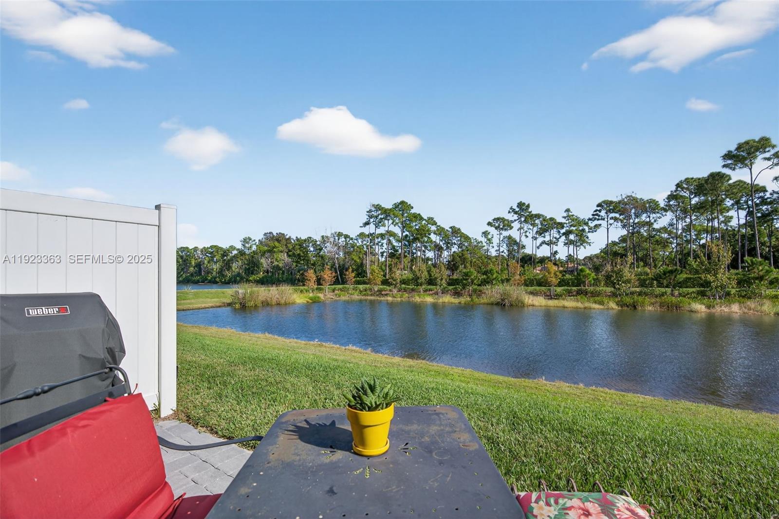 5746 Southeast Edgewater Circle Stuart, FL 34997 - Photo 32 of 38 a view of a lake with a house in the background