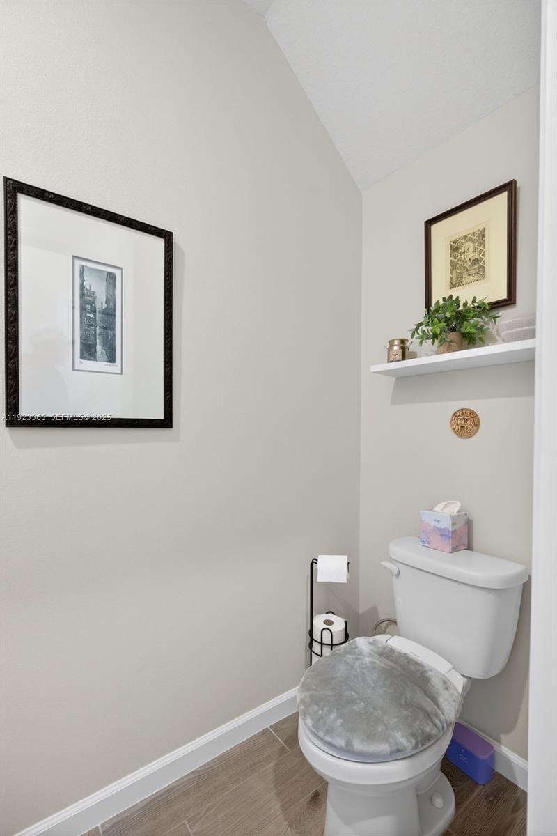 5746 Southeast Edgewater Circle Stuart, FL 34997 - Photo 5 of 38 a bathroom with a toilet and a sink