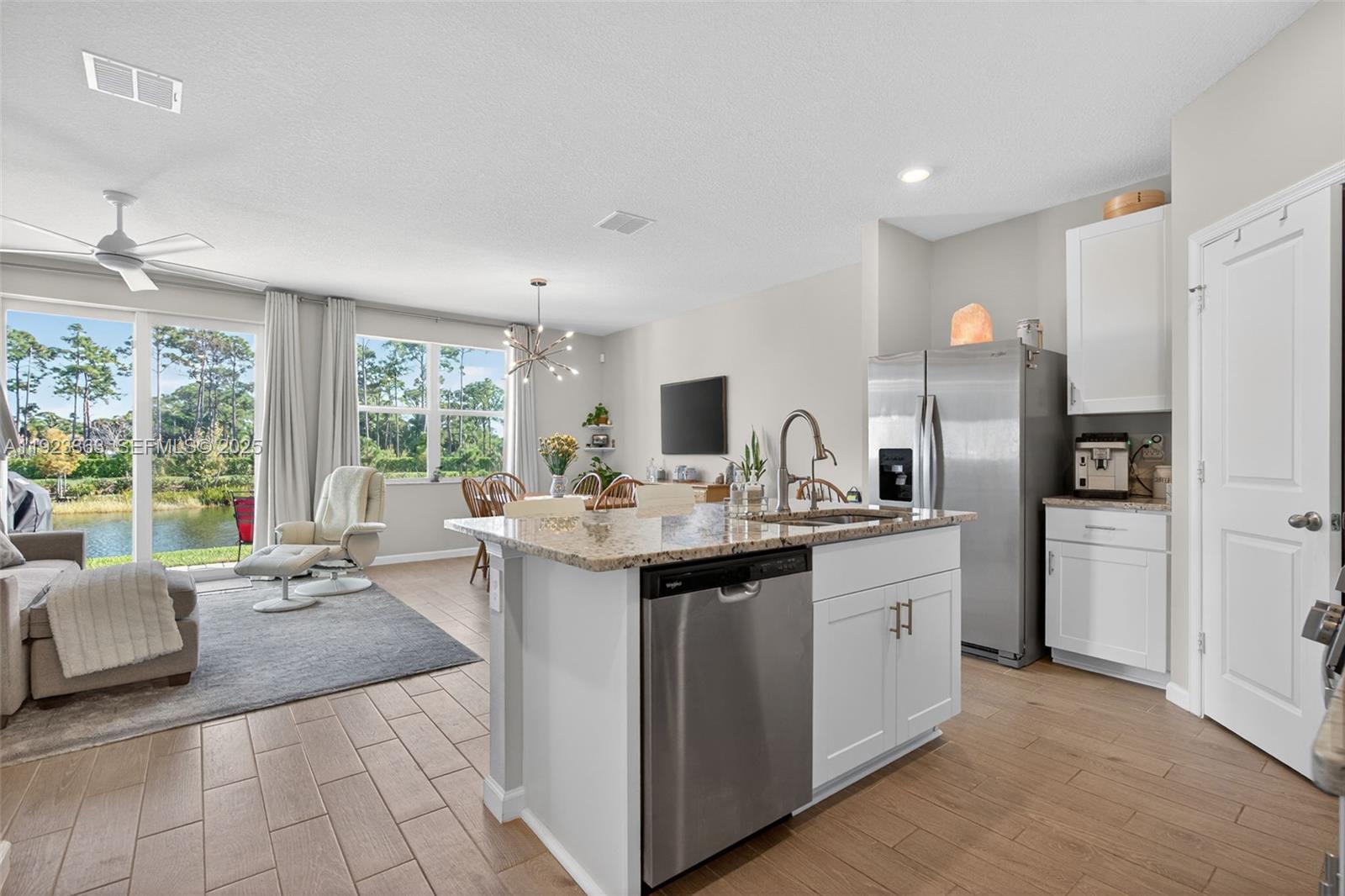 5746 Southeast Edgewater Circle Stuart, FL 34997 - Photo 6 of 38 a kitchen with sink refrigerator and large window