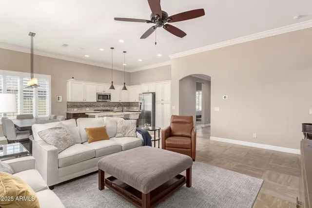 a living room with furniture and a chandelier