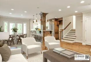 a living room with furniture and a dining table with wooden floor