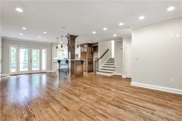 a view of empty room with wooden floor and fireplace