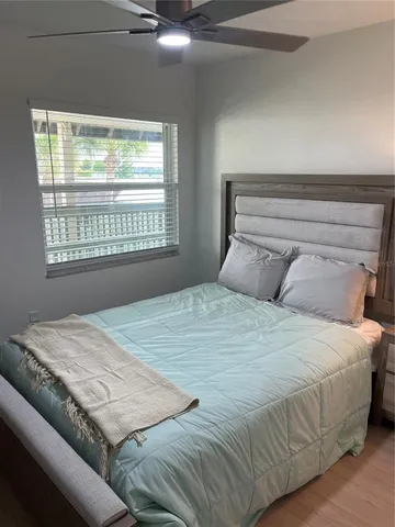 a bedroom with a bed and window