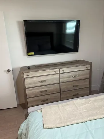 a view of living room with a flat screen tv and a fireplace