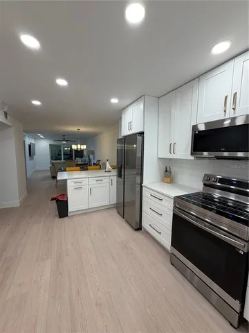 a kitchen with stainless steel appliances and white cabinets