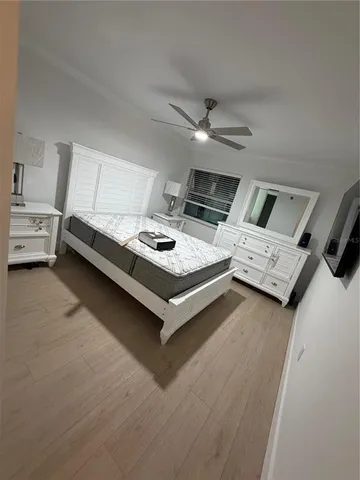 a bed room with a bed furniture and a flat screen tv