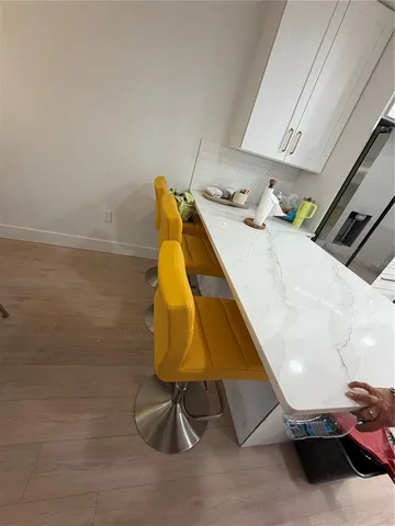 a room with wooden floor and pool table