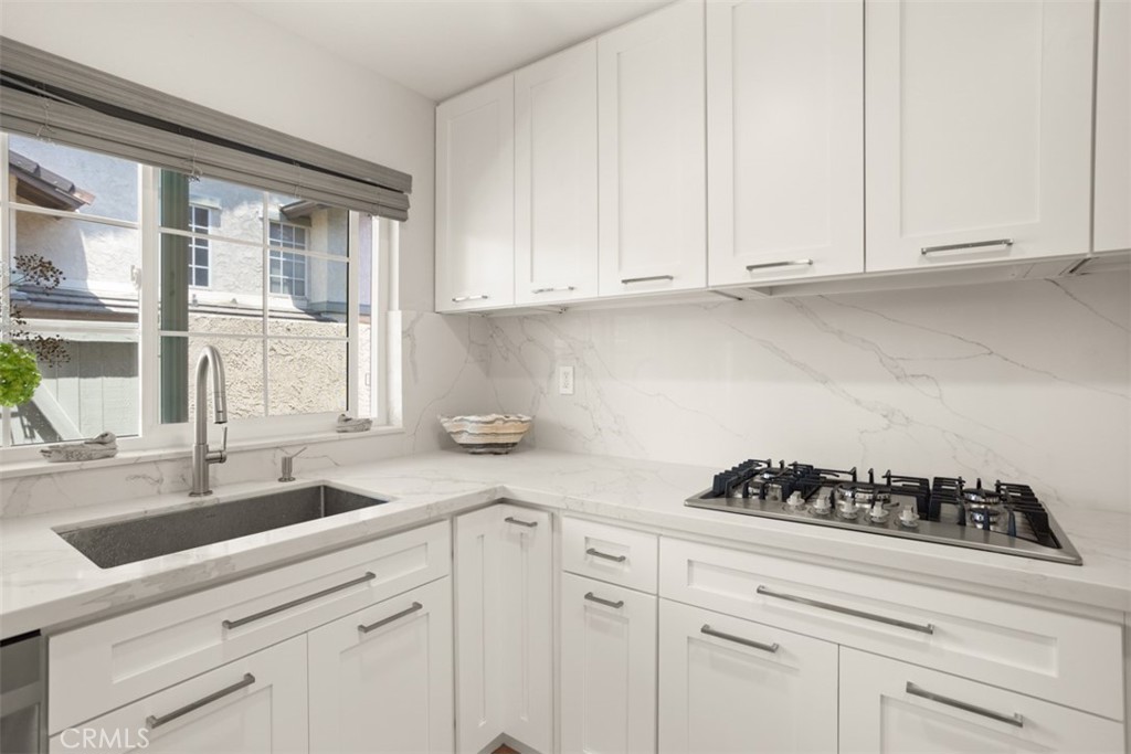 32 Columbia Irvine, CA 92612 - Photo 12 of 34 a kitchen with white cabinets and a stove