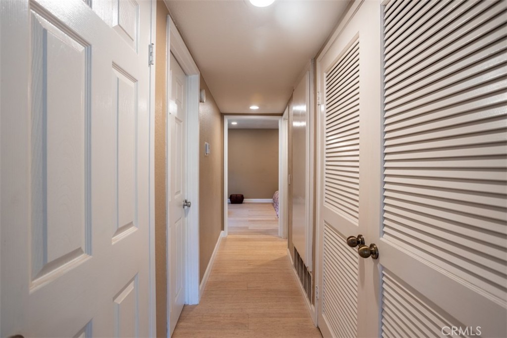 32 Columbia Irvine, CA 92612 - Photo 15 of 34 a view of a hallway with a door and wooden floor