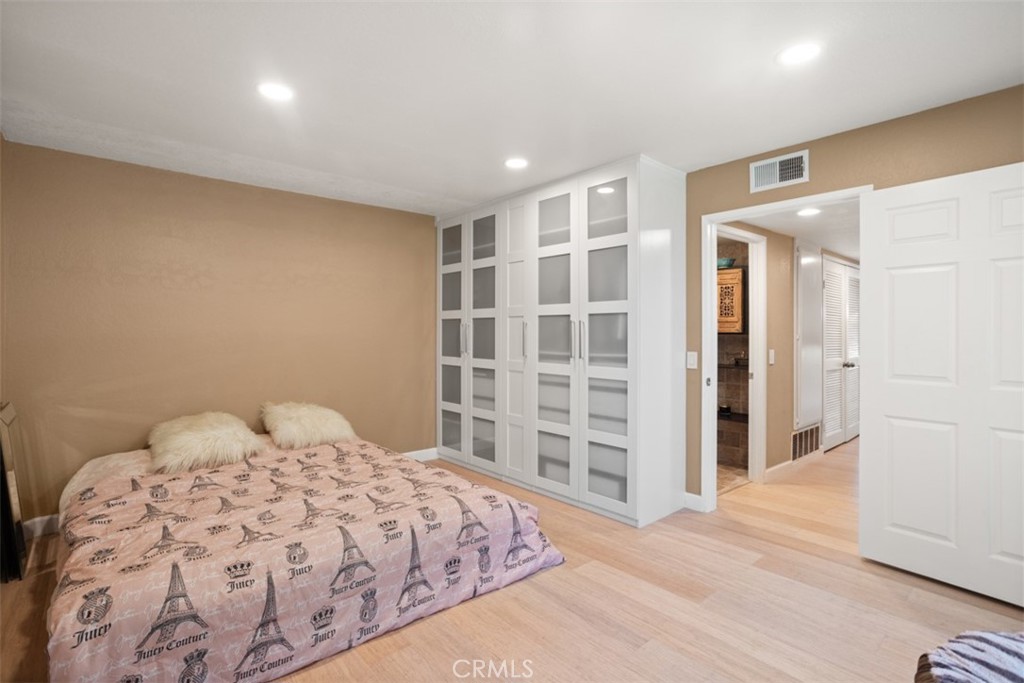 32 Columbia Irvine, CA 92612 - Photo 18 of 34 a bedroom with a large bed and wooden floor