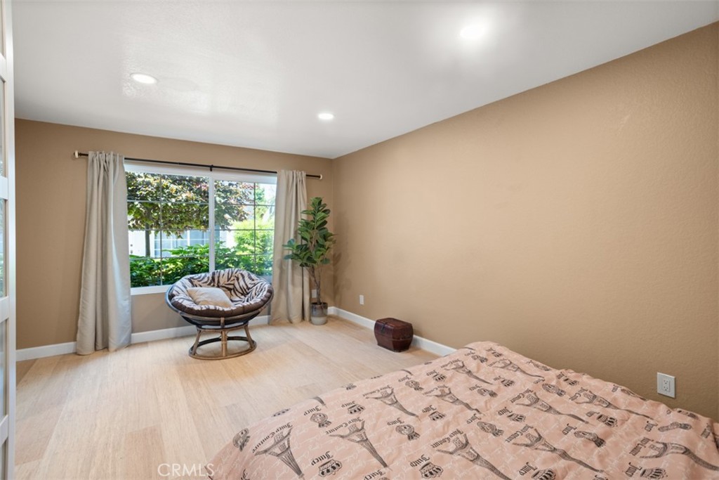 32 Columbia Irvine, CA 92612 - Photo 19 of 34 a bedroom with a bed and wooden floor