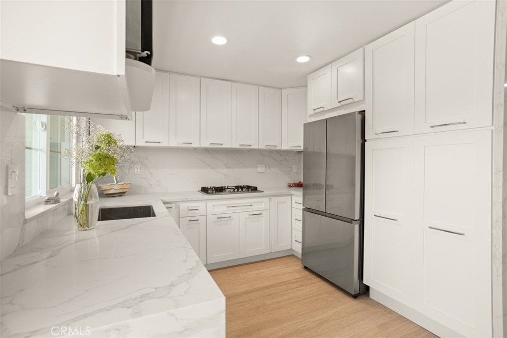 32 Columbia Irvine, CA 92612 - Photo 2 of 34 a kitchen with white cabinets and stainless steel appliances