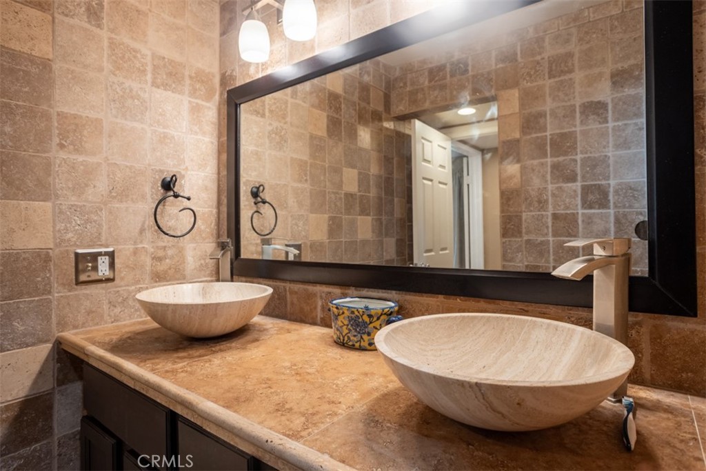 32 Columbia Irvine, CA 92612 - Photo 22 of 34 a bathroom with a granite countertop sink and a mirror