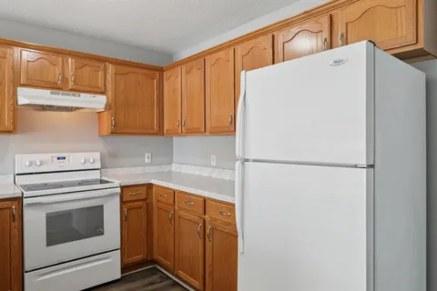 a white refrigerator freezer sitting inside of a kitchen