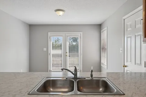 a kitchen with sink and cabinets