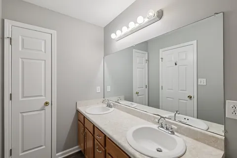 a bathroom with a sink double vanity and a mirror