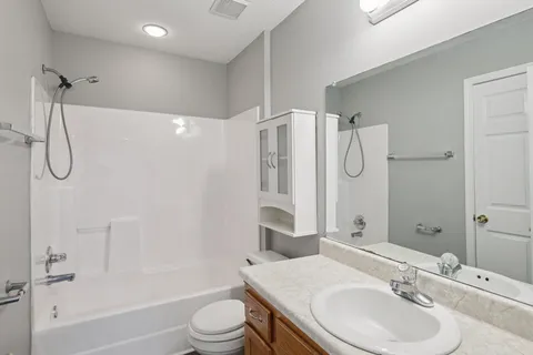 a bathroom with a sink toilet tub and shower