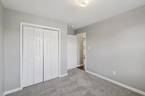 an empty room with closet area