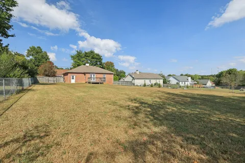a balcony with wooden floor and fence