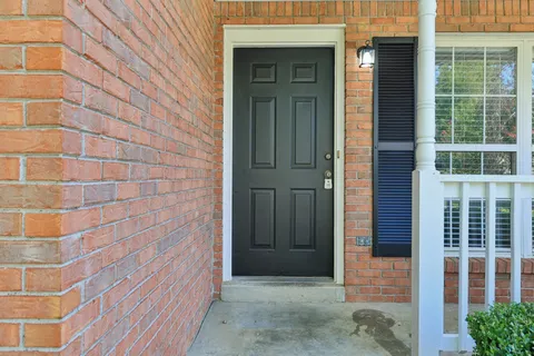 a view of a brick house with a glass door