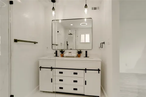a bathroom with a tub sink and mirror