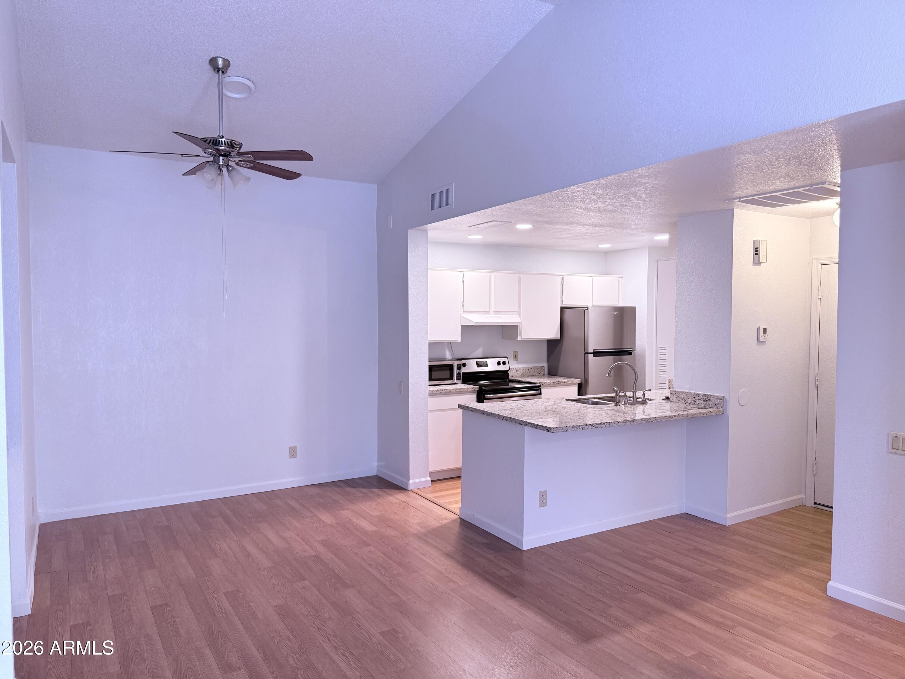 2035 South Elm Street, Unit 208 Tempe, AZ 85282 - Photo 3 of 6 a view of kitchen with sink microwave and stove