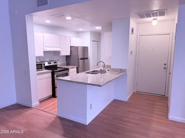 a kitchen with kitchen island a sink appliances and cabinets