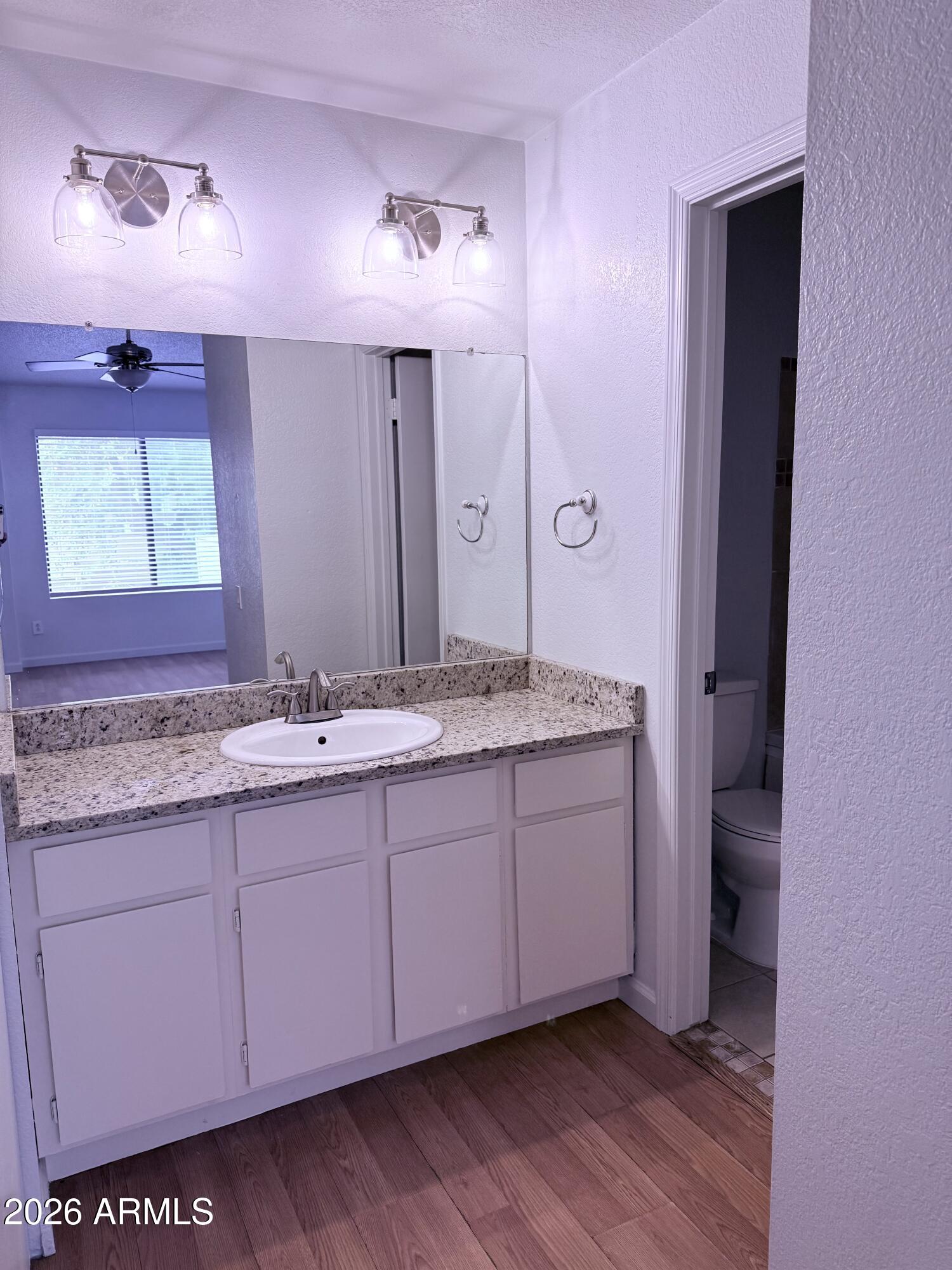2035 South Elm Street, Unit 208 Tempe, AZ 85282 - Photo 6 of 6 a bathroom with a granite countertop sink and a mirror