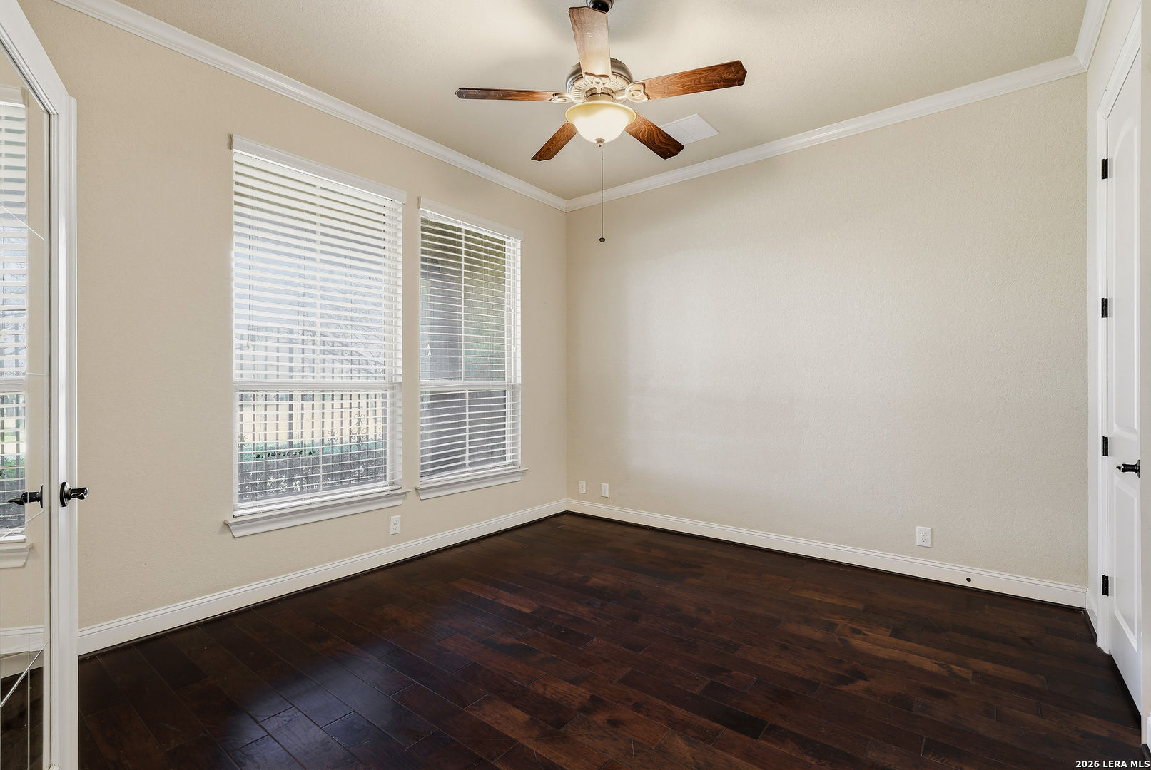 19414 Arrowood Place Garden Ridge, TX 78266 - Photo 13 of 25 a view of an empty room with wooden floor and a window