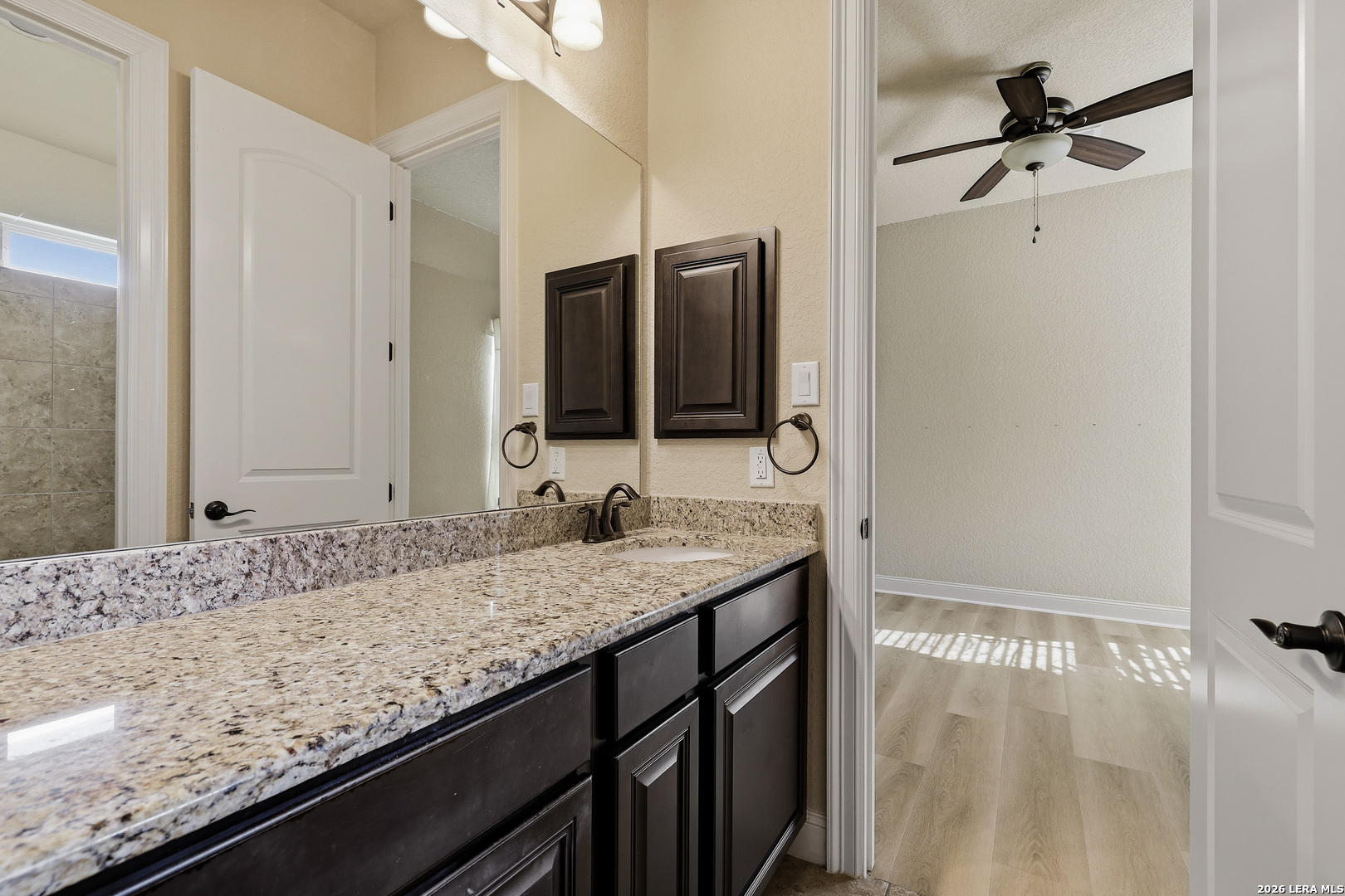 19414 Arrowood Place Garden Ridge, TX 78266 - Photo 20 of 25 a bathroom with a granite countertop sink and a mirror