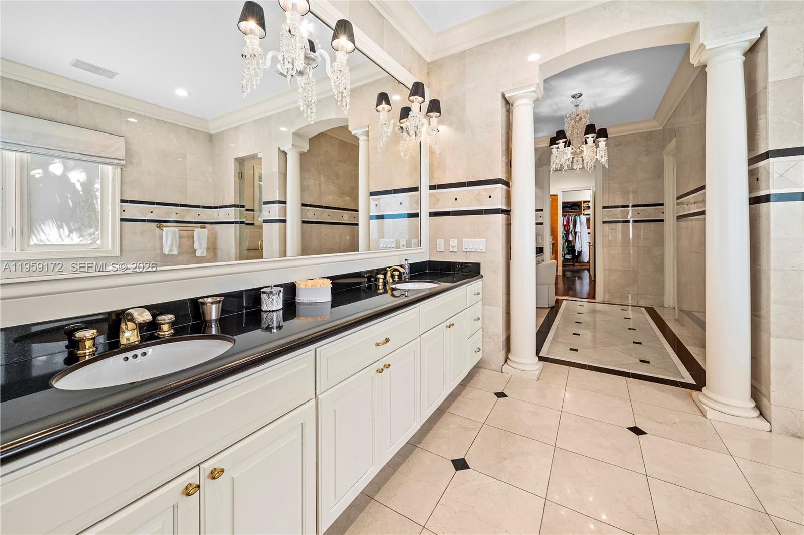 8400 School House Road Miami, FL 33143 - Photo 46 of 66 a hallway with white cabinets and chandelier