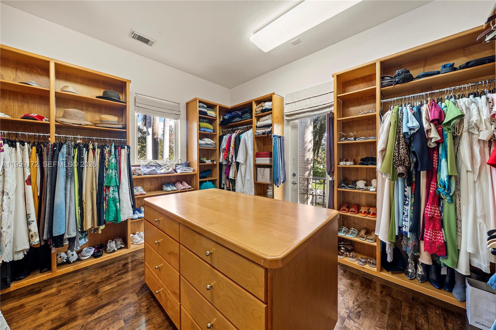 8400 School House Road Miami, FL 33143 - Photo 47 of 66 a view of walk in closet with clothes and shoes