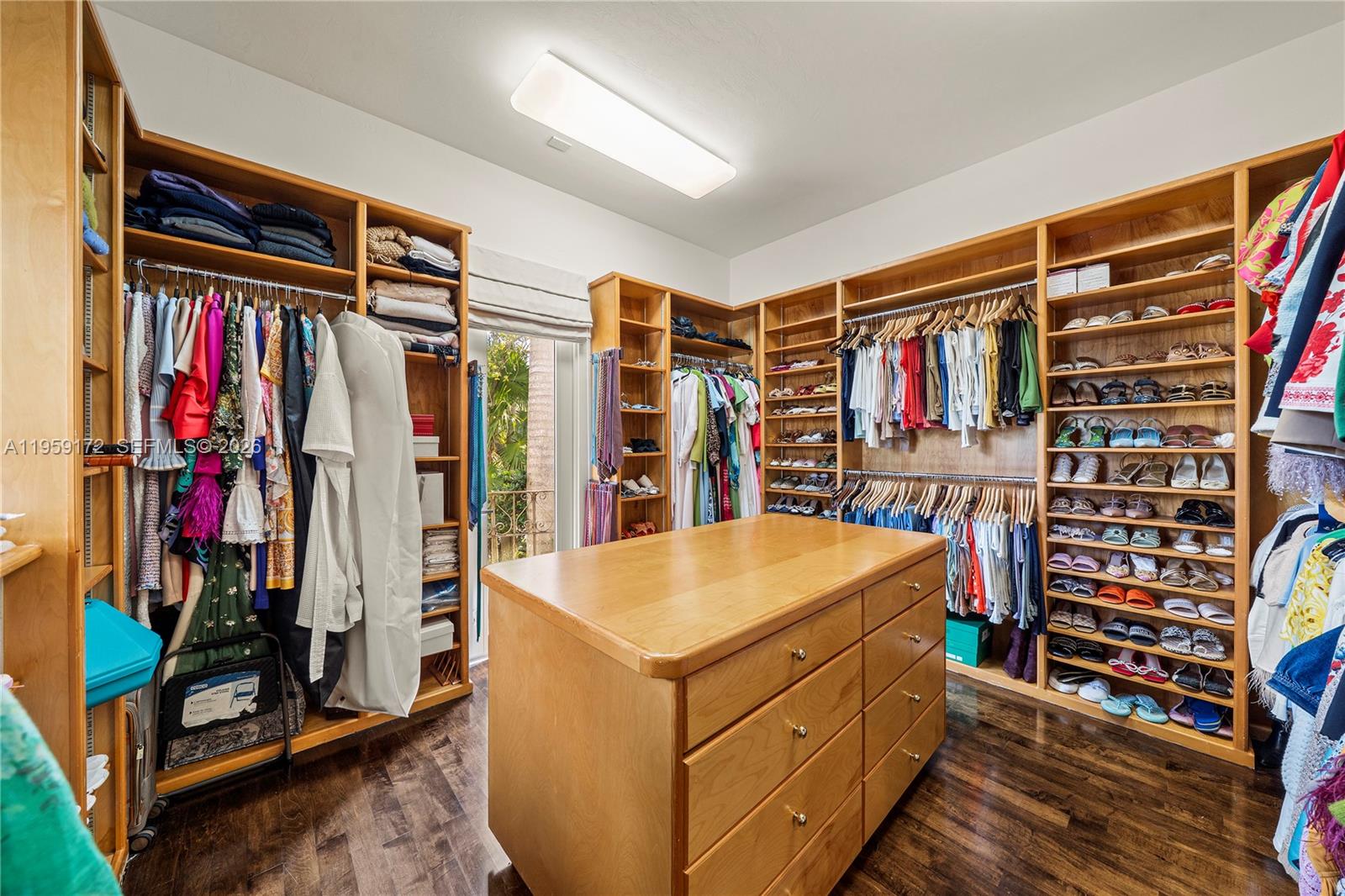 8400 School House Road Miami, FL 33143 - Photo 48 of 66 a view of walk in closet with clothes and shoes