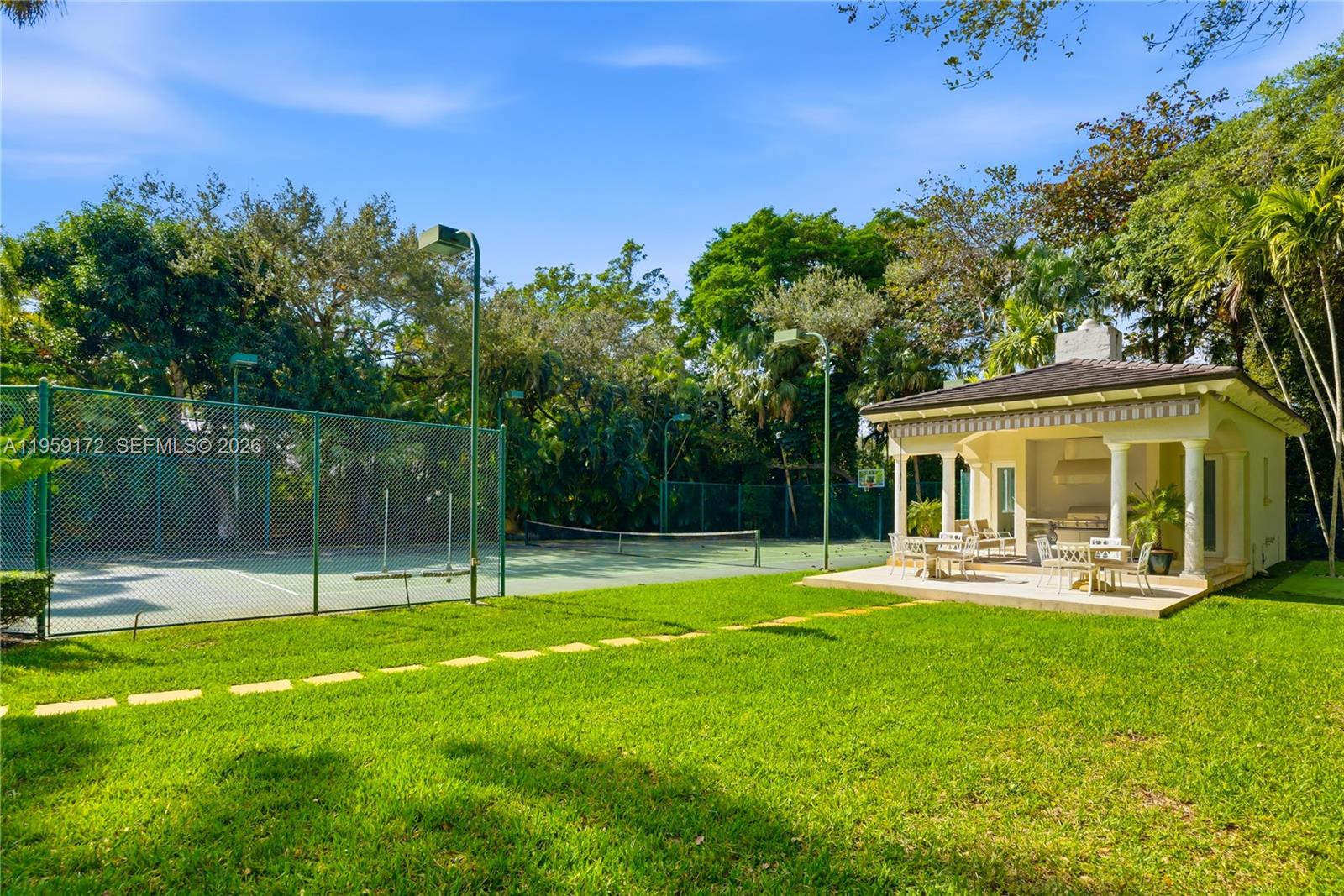 8400 School House Road Miami, FL 33143 - Photo 63 of 66 a view of a house with a backyard and a patio