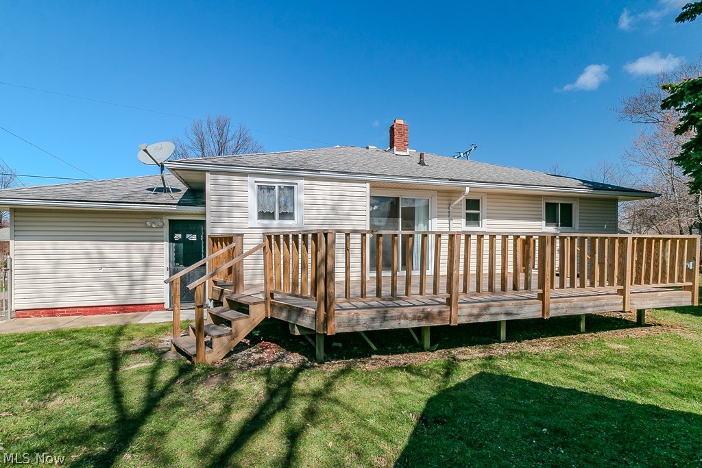 30224 Regent Road Wickliffe, OH 44092 - Photo 25 of 27 Rear view of property featuring a lawn, a wooden deck, a chimney, and a shingled roof