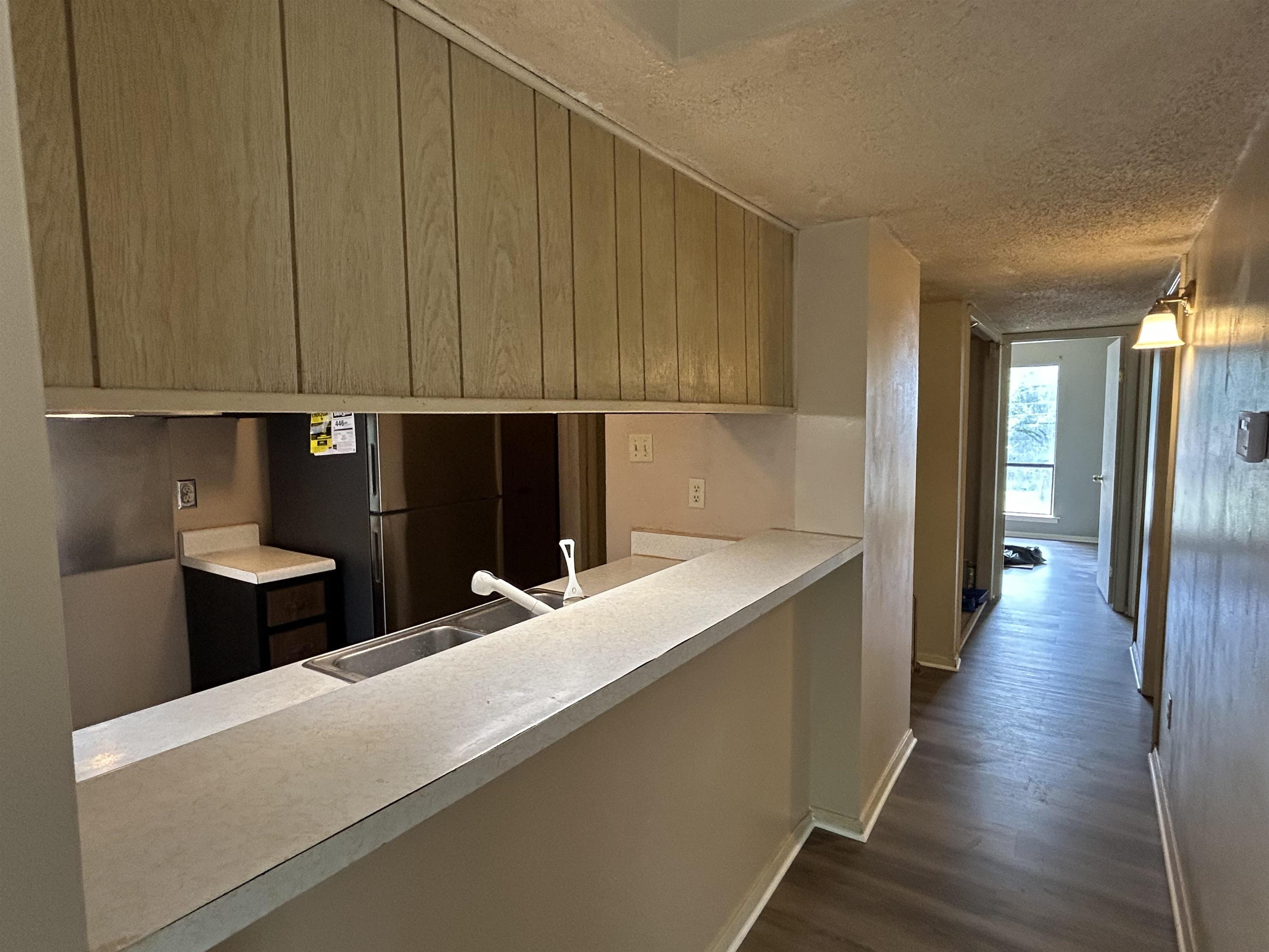 2800 Clarke Road, Unit 2 Memphis, TN 38115 - Photo 6 of 18 Kitchen pass-through featuring an integrated stainless steel sink and laminate countertops
