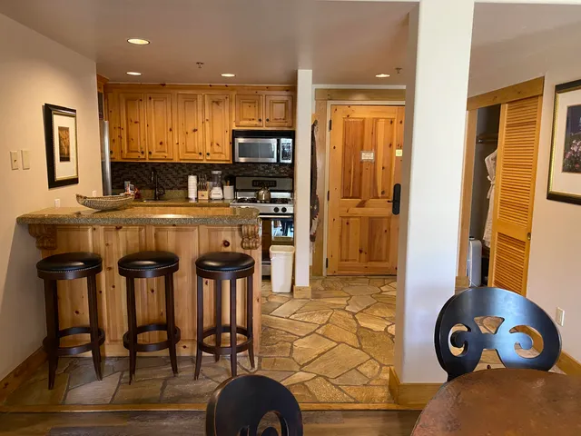 a kitchen with stainless steel appliances granite countertop a stove and a refrigerator