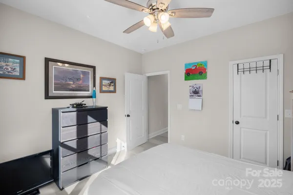 a bedroom with a bed a dresser and a book shelf