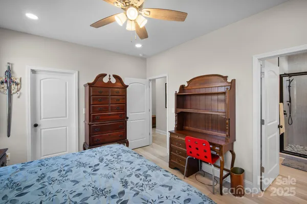 a large bathroom with a granite countertop sink a mirror and shower