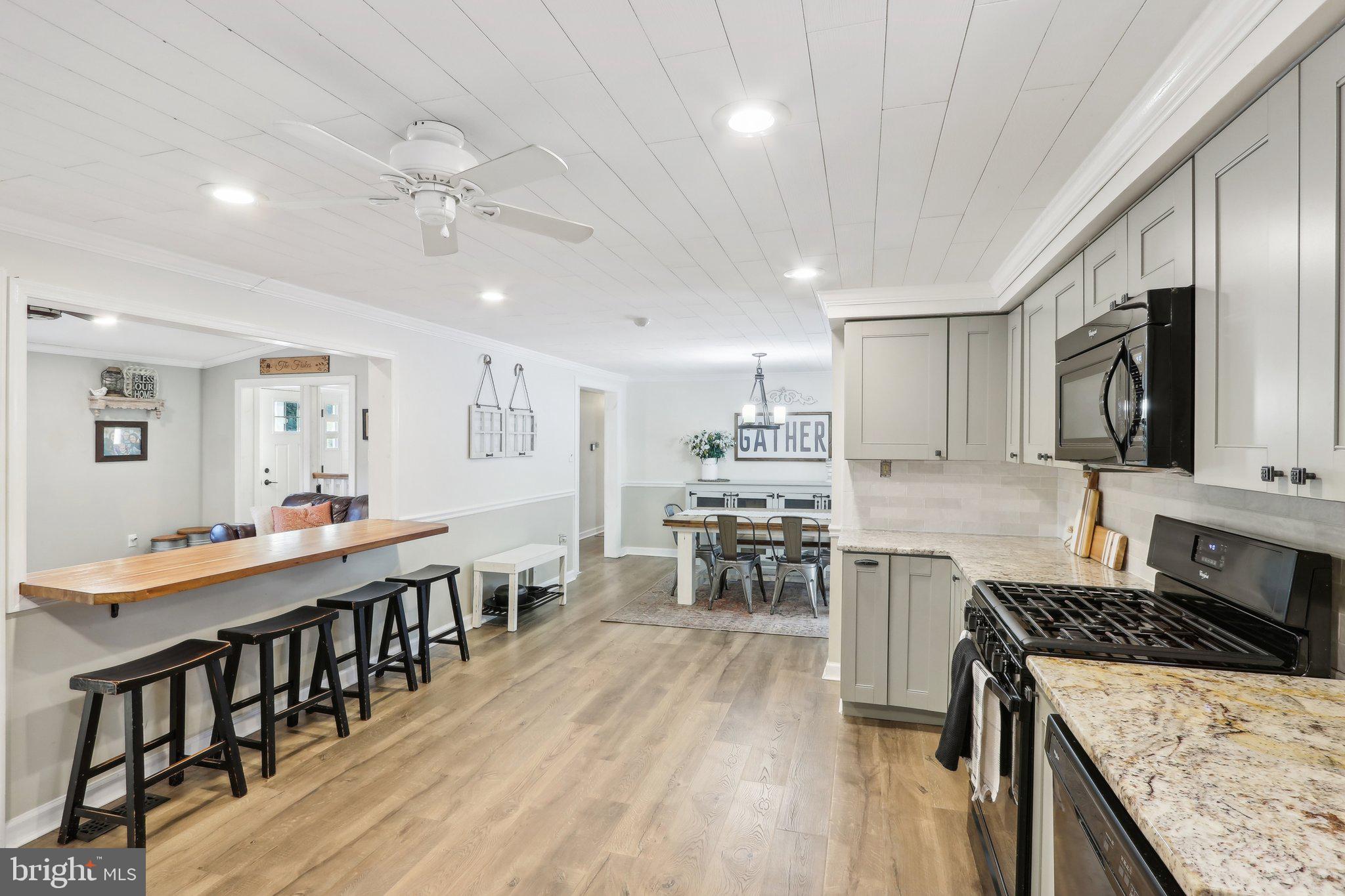 364 Almond Road Pittsgrove, NJ 08318 - Photo 36 of 51 a large kitchen with kitchen island a wooden floor stove center island and stainless steel appliances