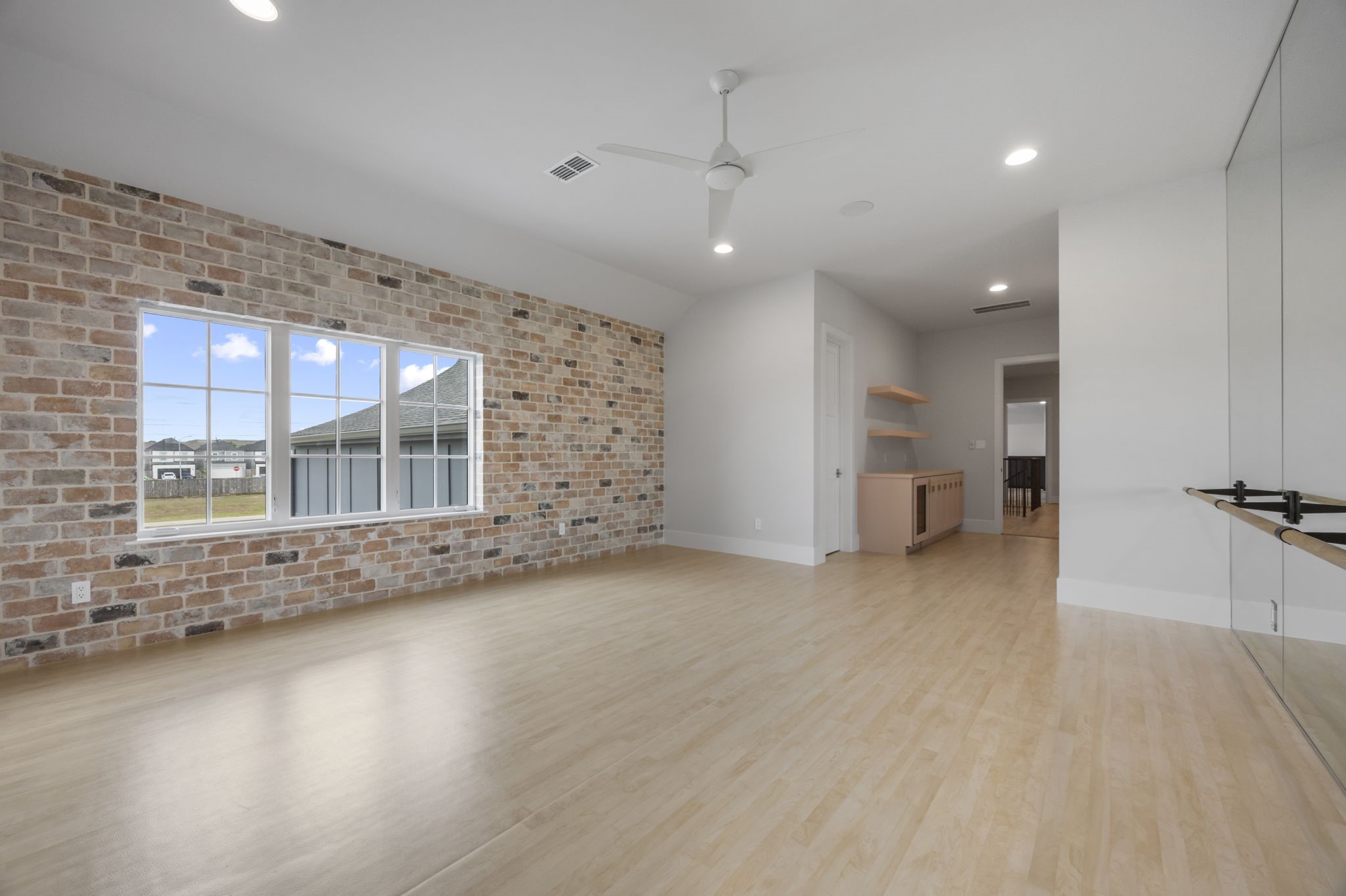 4233 Two Gun Way Katy, TX 77494 - Photo 44 of 47 Upstairs ballet/dance studio with brick wall, across from wall of mirrors with ballet bar. This could also be an 8th bedroom with large closet.