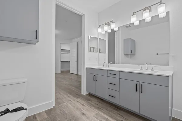 a bathroom with a double vanity sink and a mirror