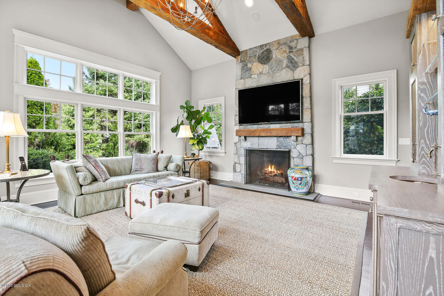 7 Finney Knoll Riverside, CT 06878 - Photo 11 of 30 a living room with furniture a flat screen tv and a fireplace
