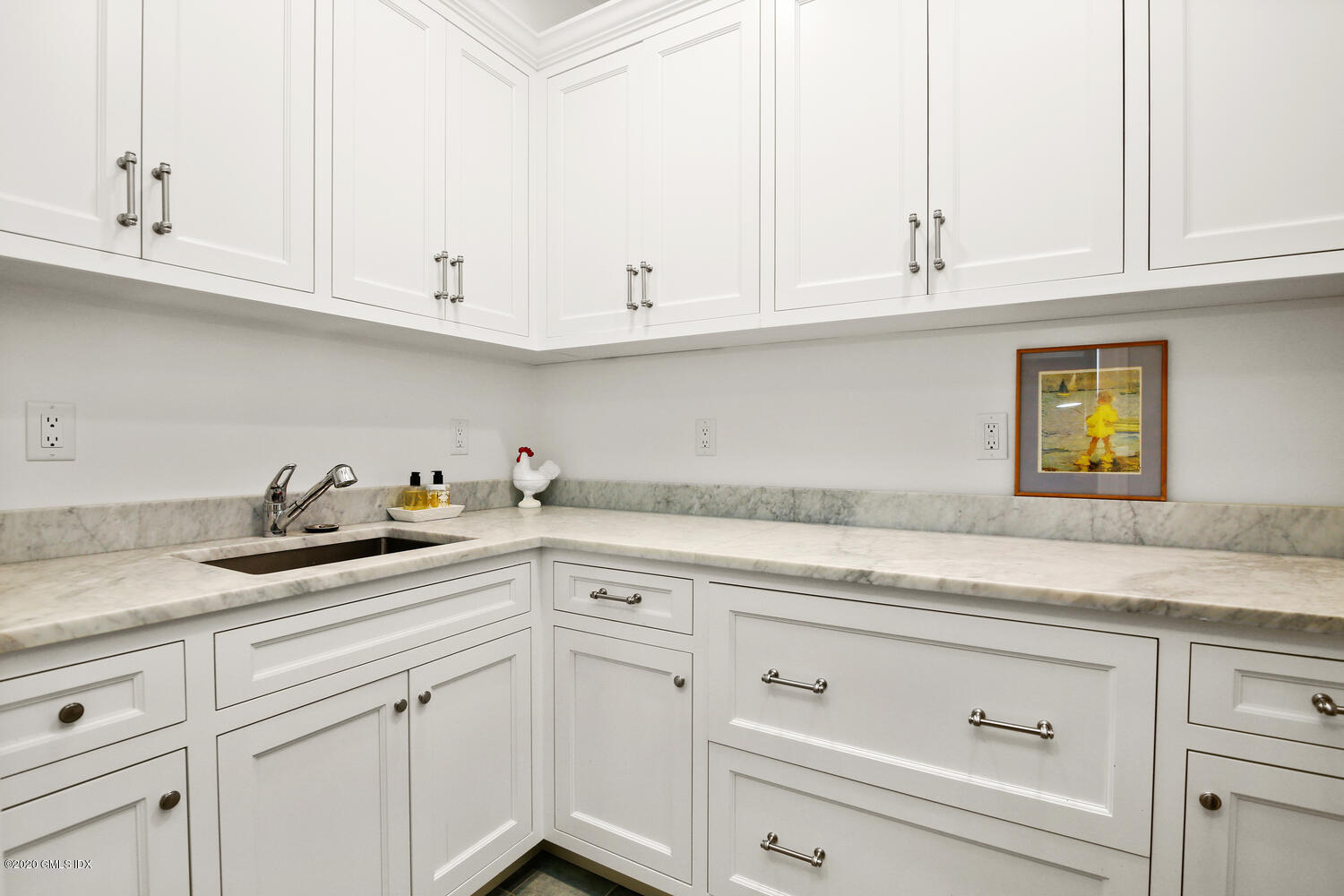 7 Finney Knoll Riverside, CT 06878 - Photo 23 of 30 a kitchen with white cabinets and a sink