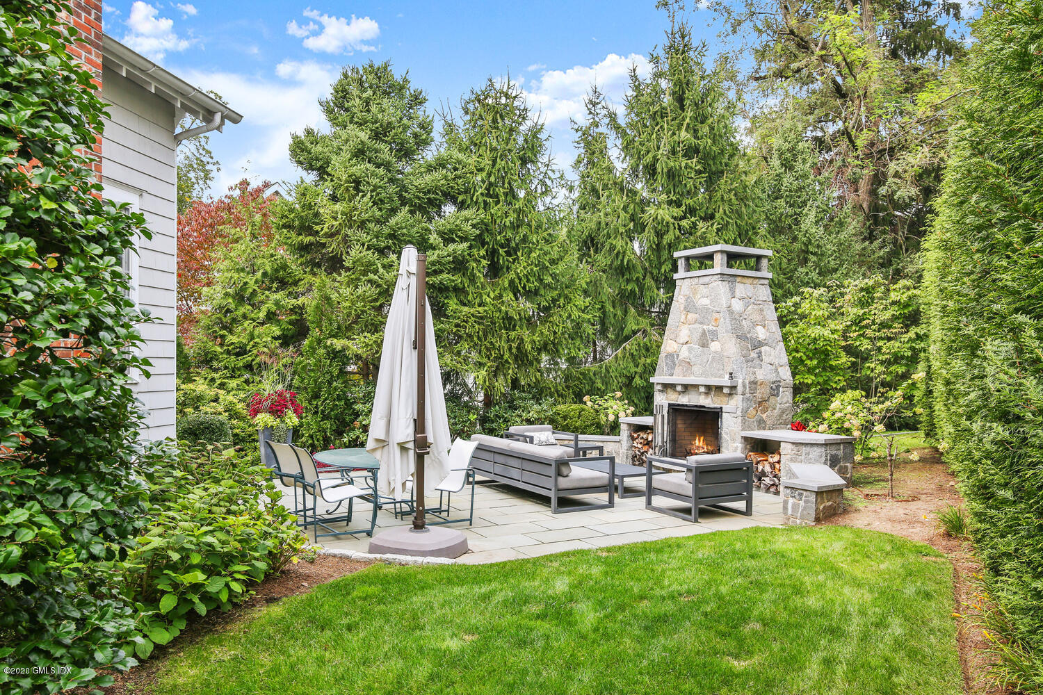 7 Finney Knoll Riverside, CT 06878 - Photo 25 of 30 a view of a chair and table in backyard of the house