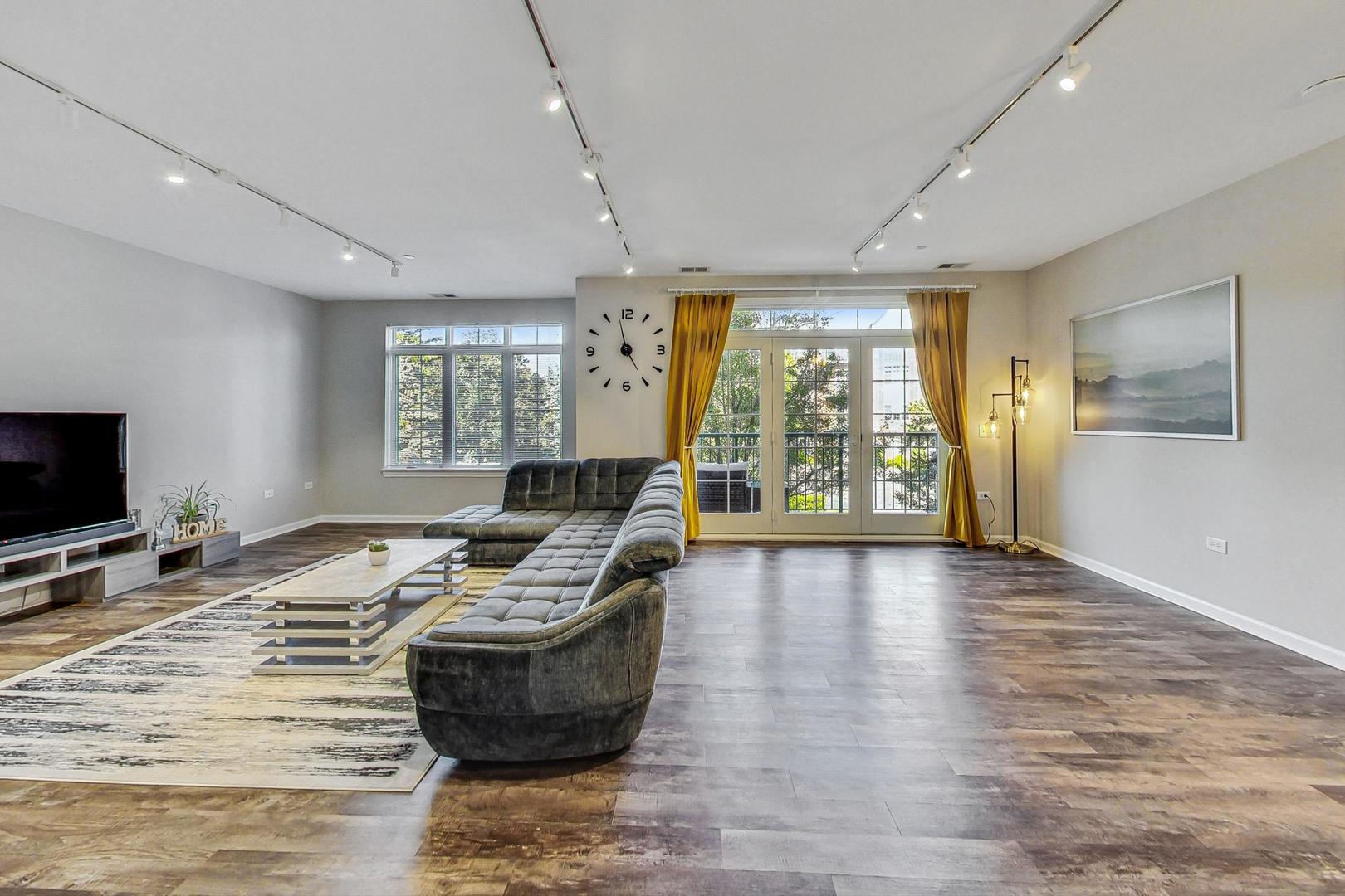 640 McHenry Road, Unit 203 Wheeling, IL 60090 - Photo 12 of 41 a room with furniture and flat screen tv