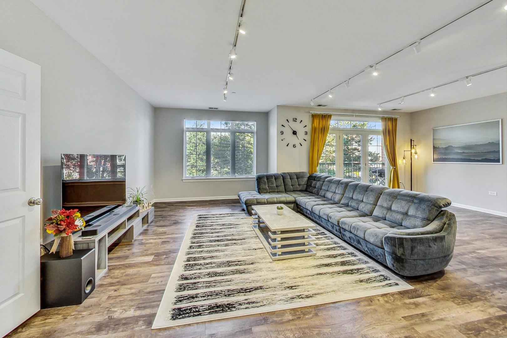 640 McHenry Road, Unit 203 Wheeling, IL 60090 - Photo 13 of 41 a living room with furniture and a flat screen tv