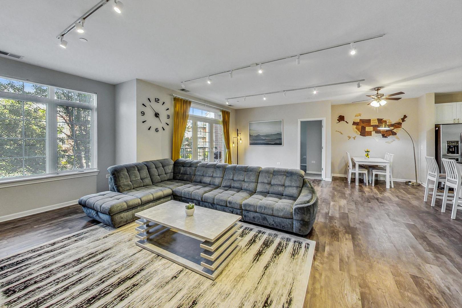 640 McHenry Road, Unit 203 Wheeling, IL 60090 - Photo 14 of 41 a living room with furniture and a large window