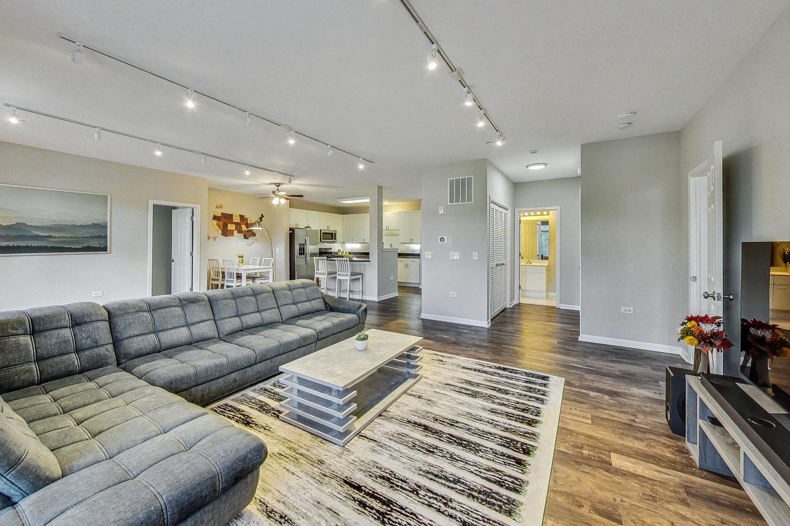 640 McHenry Road, Unit 203 Wheeling, IL 60090 - Photo 15 of 41 a living room with furniture and a flat screen tv